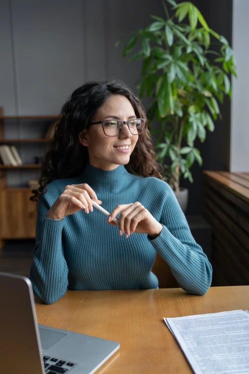 happy businesswoman entrepreneur look in window smile after successful online laptop video meeting e1664981475749
