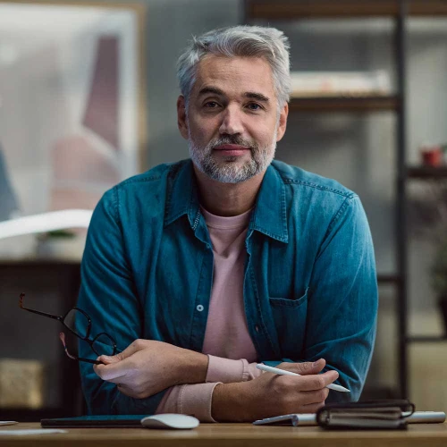 mature man 2 architect working on tablet at desk ind XNYH6RZ
